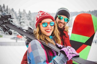 Guy and girl snowboard excess baggage Canada