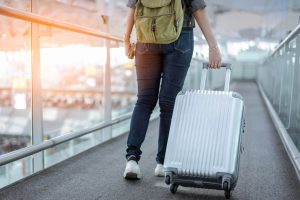Person pulling their suitcase through airport